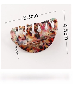 Macro view of large PVC hair claw clip showing marble pattern and 8.3cm dimensions