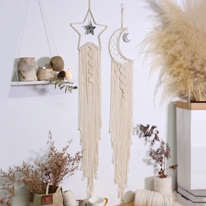 Bohemian woven moon and star wall hanging made of beige cotton rope for home decor