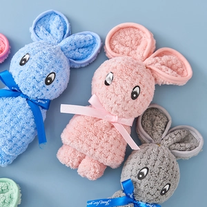Close-up of coral fleece hand towels folded into rabbit shapes in pastel blue and pink