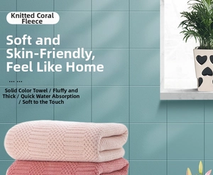Detail view of thick coral fleece bath towels showing soft texture and high absorption