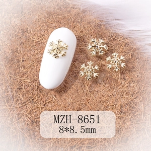 Close-up of golden alloy snowflake nail charms for winter manicure decoration 8x8.5mm