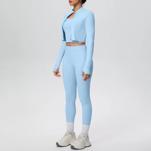 Close-up of women's light blue yoga set featuring a zip jacket and high-waist leggings