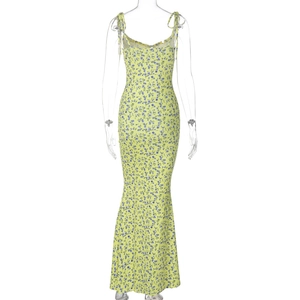 Detailed close-up of blue floral print on yellow summer maxi dress with fishtail hemline