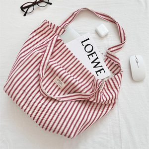 Spacious red and white striped canvas tote bag holding a laptop and office accessories