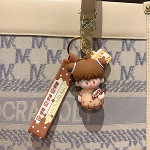 Cute brown bubble tea girl keychain charm on a beige bag, creative cartoon accessory