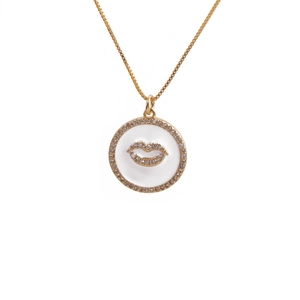 Gold plated necklace featuring a white enamel round pendant with a zircon encrusted lip motif
