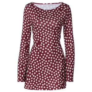 Detailed view of the burgundy fabric with white polka dots and long sleeve cuffs