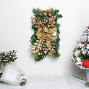 Detail of Christmas wreath featuring gold ribbons and pine needles for wall decoration
