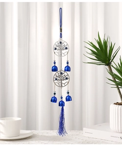 Detail of blue evil eye wind chime with tree of life metal ring and hanging tassels