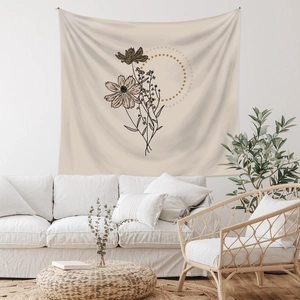 Minimalist beige wall tapestry with black line floral art in a cozy living room decor setting
