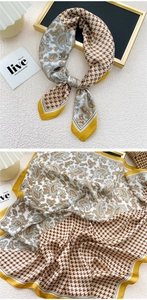 Detail of square silk scarf with brown houndstooth and yellow paisley patchwork pattern