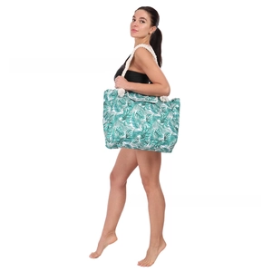 Detail of tropical palm leaf print tote bag with thick beige rope handles for beach use