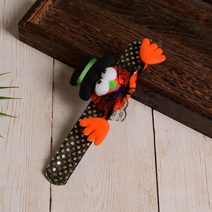 Detail of Halloween sequin slap bracelet featuring an orange ghost with a black top hat