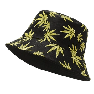 Detailed close-up of yellow leaf patterns on black canvas street style bucket hat