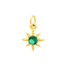 Macro detail of 18K gold plated star pendant with a sparkling green zircon centerpiece