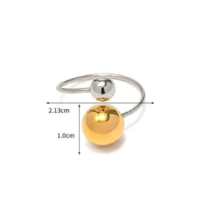 Close-up of dual-tone open ring featuring 1.0cm gold bead and silver ball detail