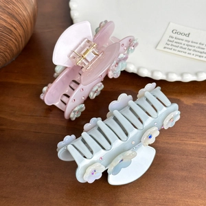 Elegant floral acetate hair claws in pink and blue with sparkly rhinestone accents