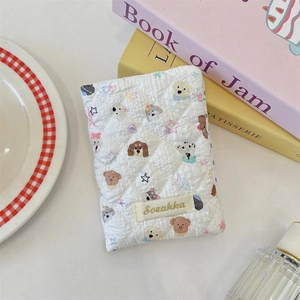 Quilted white travel passport holder featuring cute cartoon dog patterns and stars
