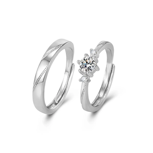 Silver couples ring set with six-prong moissanite engagement ring and engraved band