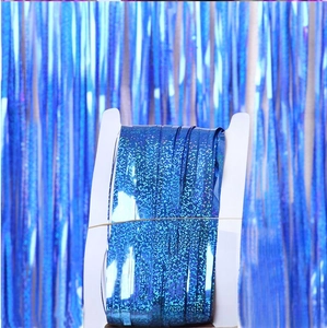 Close-up of blue laser rain curtain foil fringe party streamers on a white card spool