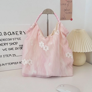 Detailed close-up of pink tulle tote bag featuring white 3D floral lace embroidery