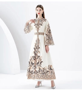 Macro detail of Bohemian paisley print on long-sleeved dress with high neck and belt