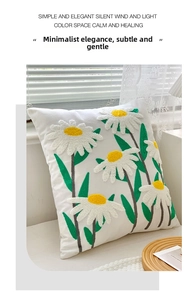 Detailed view of 3D daisy embroidery on a white square cushion with floral textures