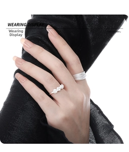 Wearing display of S925 sterling silver rings with floral clusters and layered band design