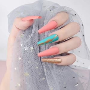 Close-up of long coffin press-on nails with matte coral pink, blue marble and gold glitter