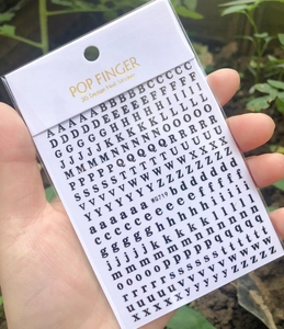 3D nail art stickers featuring black and white alphabet letters and numbers in outdoor light