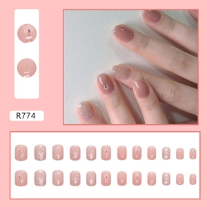 Detailed view of 24pcs pink French press-on nails with glitter and floral designs