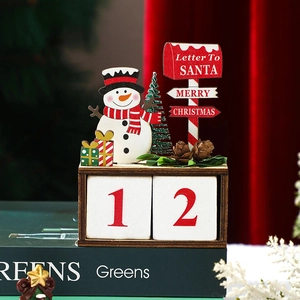 Close-up of wooden Christmas countdown calendar with snowman and Santa letterbox