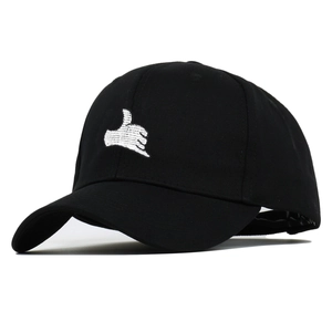 Close-up of black cotton baseball cap featuring detailed white hand gesture embroidery