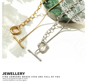 Macro detail of OT toggle clasp and dual-chain necklace with lava textured ring finish