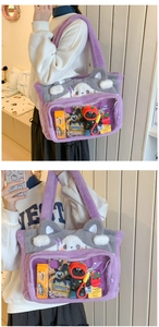 Detail of purple plush cat shoulder bag with large transparent PVC display window