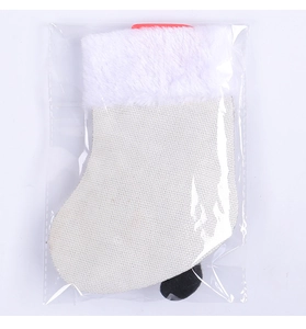 Close-up of white linen Christmas stocking with plush cuff in clear packaging