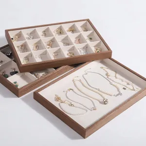 Walnut wood grain jewelry display tray with white velvet lining for rings and necklaces