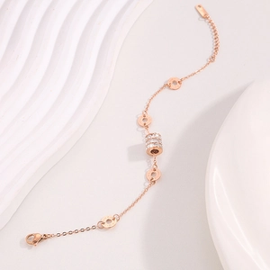 Elegant rose gold stainless steel bracelet with crystal-studded triple ring charms