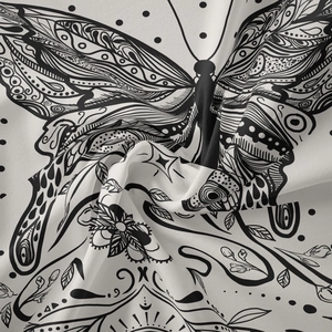 Detailed macro view of black and white butterfly and floral pattern on fabric tapestry