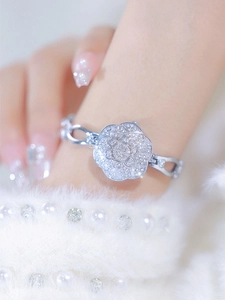 Close-up of silver flower bracelet watch with sparkling zircons on a model wrist
