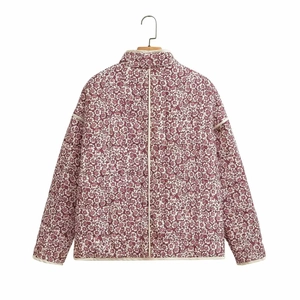 Detail view of the quilted texture and vintage floral print on a cotton jacket