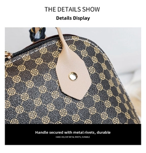 Close-up of shell bag featuring durable golden rivet hardware and floral pattern leather