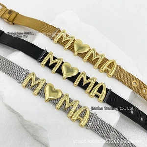 Close-up of stainless steel mesh bracelets in gold, black, and silver with M heart MA letters