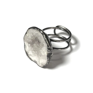 Detailed view of large raw geode agate stone with handcrafted silver plated wire wrap band