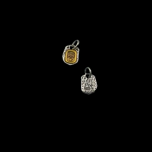 Close-up of two-tone silver and gold Tibetan deity pendant for DIY jewelry making