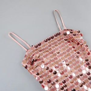 Detail shot of shimmering pink sequins and thin straps on a luxurious cocktail dress