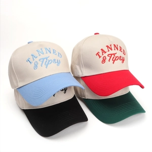 Detailed embroidery of TANNED & Tipsy logo on colorful cotton trucker baseball caps