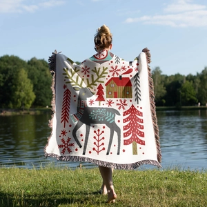 Detailed knit texture of a Christmas reindeer cotton throw blanket with colorful fringes