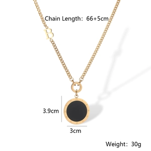 Detail view of gold titanium necklace with Roman numerals pendant and B letter charm