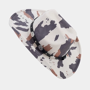 Close-up of cowboy hat showing cow print pattern and silver engraved metal buckles